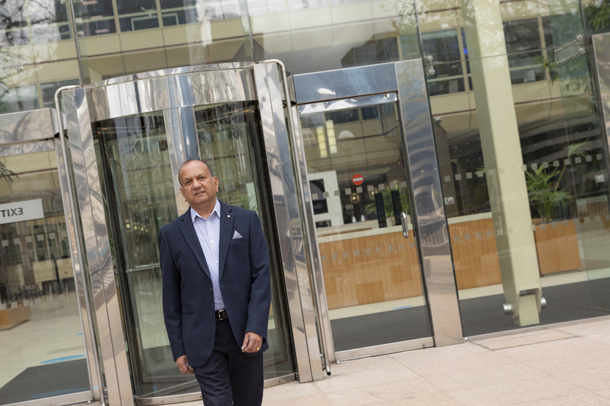 A man walking out of an office building in colour