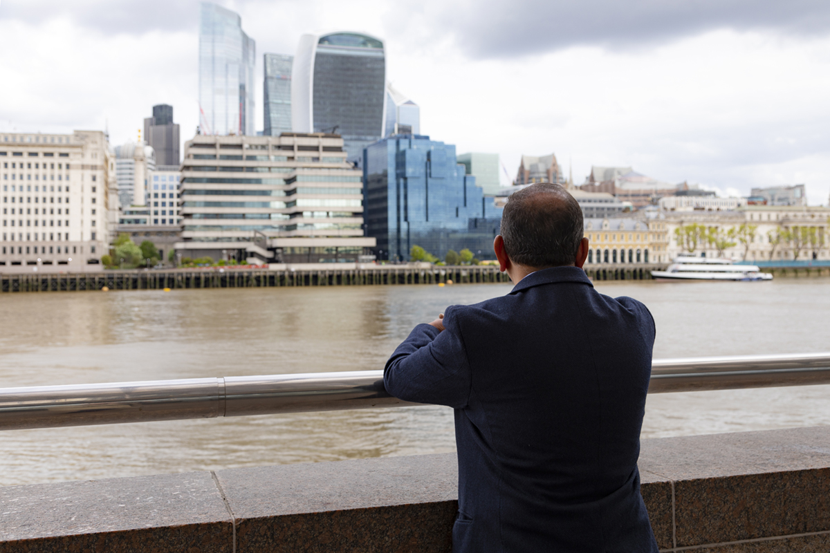 A man looking out across the river Thames.