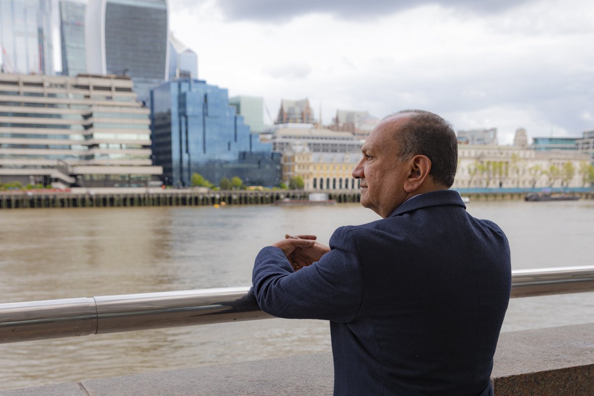 A man looking out across the river Thames.